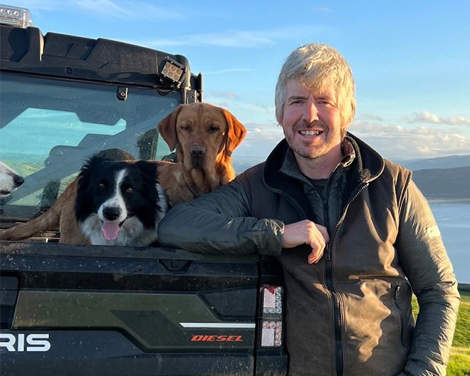 man with dogs smiling