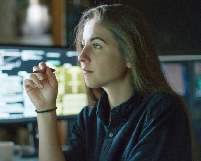 young woman in an office looking at her screen