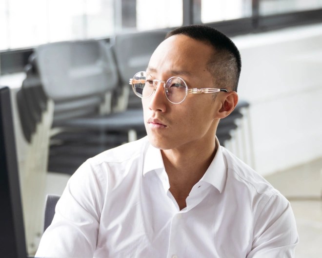 man in an office looking at his computer