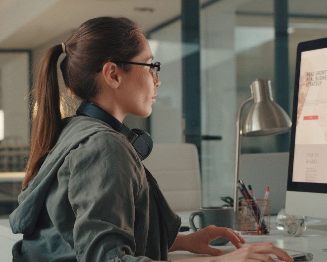 woman in an office looking at her computer