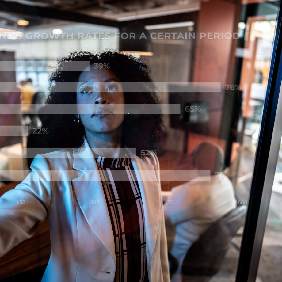 Young business woman using augmented reality device at office.