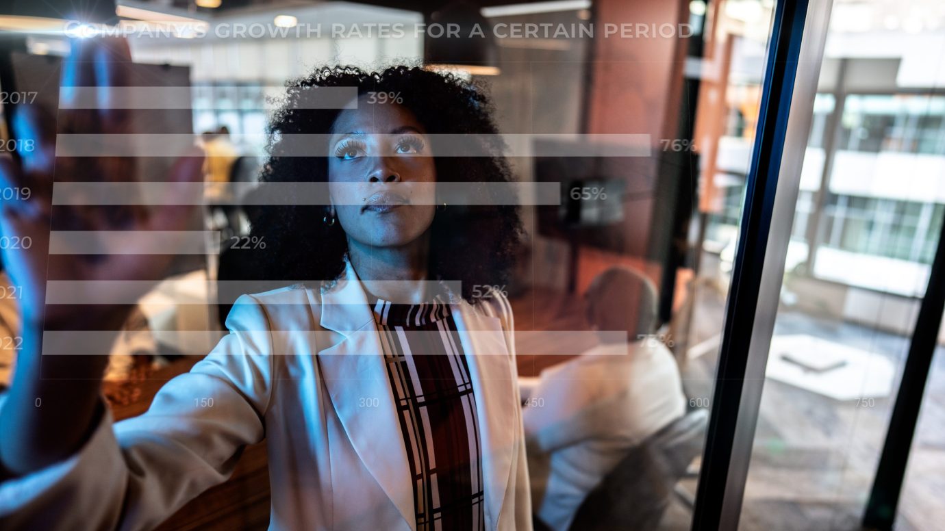 Young business woman using augmented reality device at office.