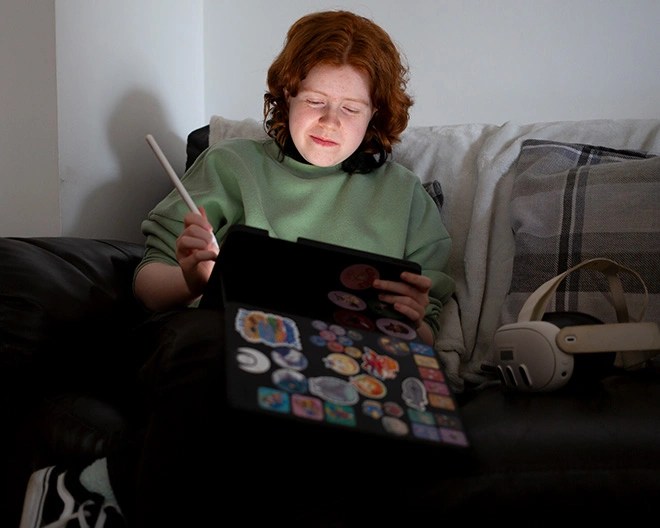 Woman with tablet and pen on couch