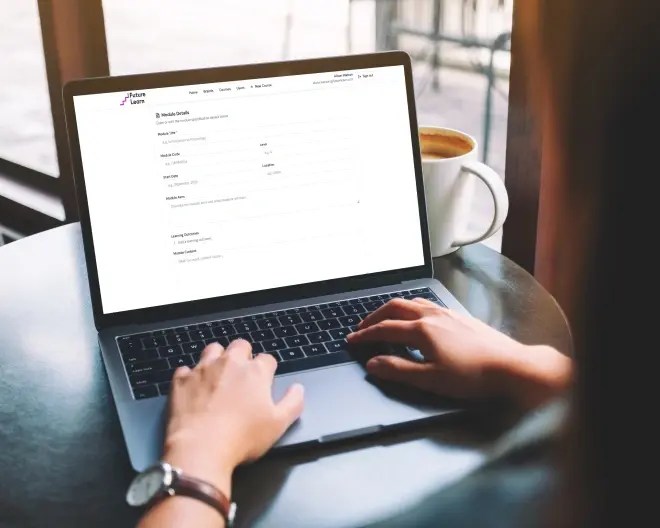 Close-up of a person’s hands typing on a laptop, with module specification details displayed on the screen.