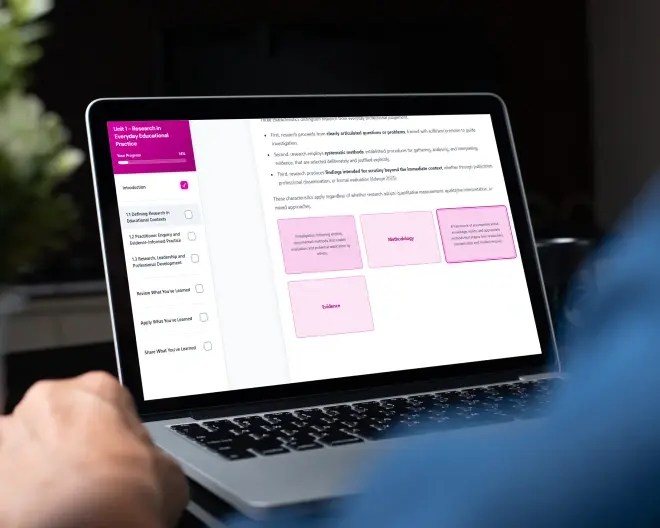 Close-up of a person’s hands typing on a laptop on their lap, with a module development page displayed on the screen.