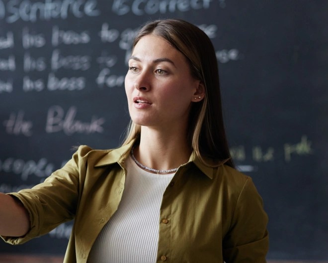 woman stood in front of a blackboard