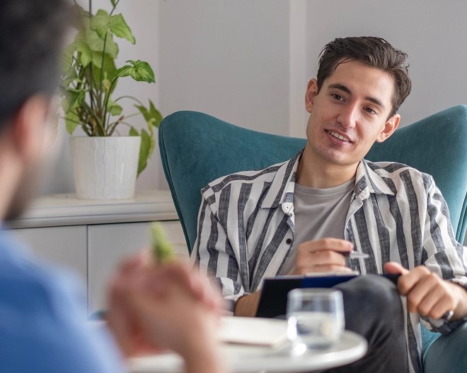 Man sitting across therapist having a session