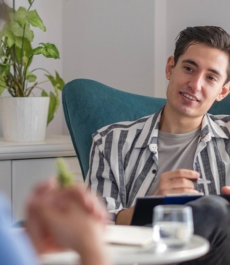 Man sitting across therapist having a session